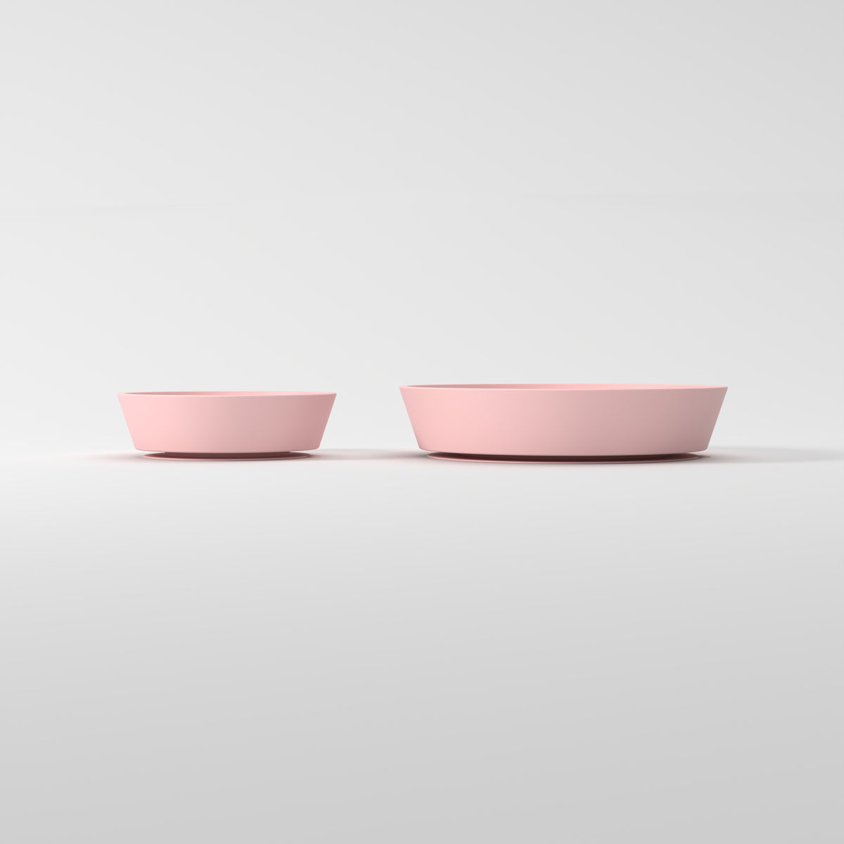Small and Medium Pink Star + Cloud slow feeder bowls, size comparison side studio view