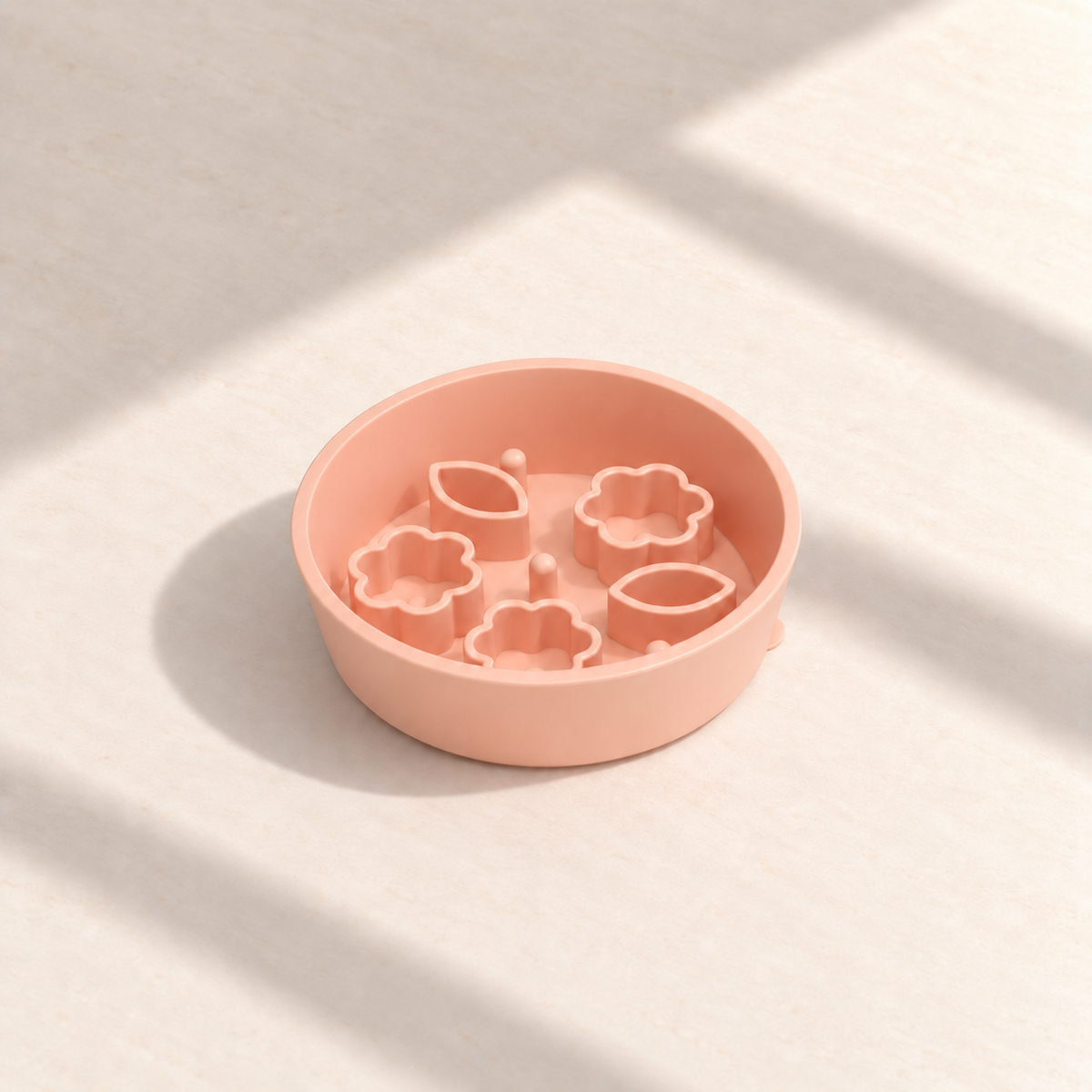 Peach Flower + Leaf slow feeder bowl, 5.5-inch diameter, empty on a sunlit cream table