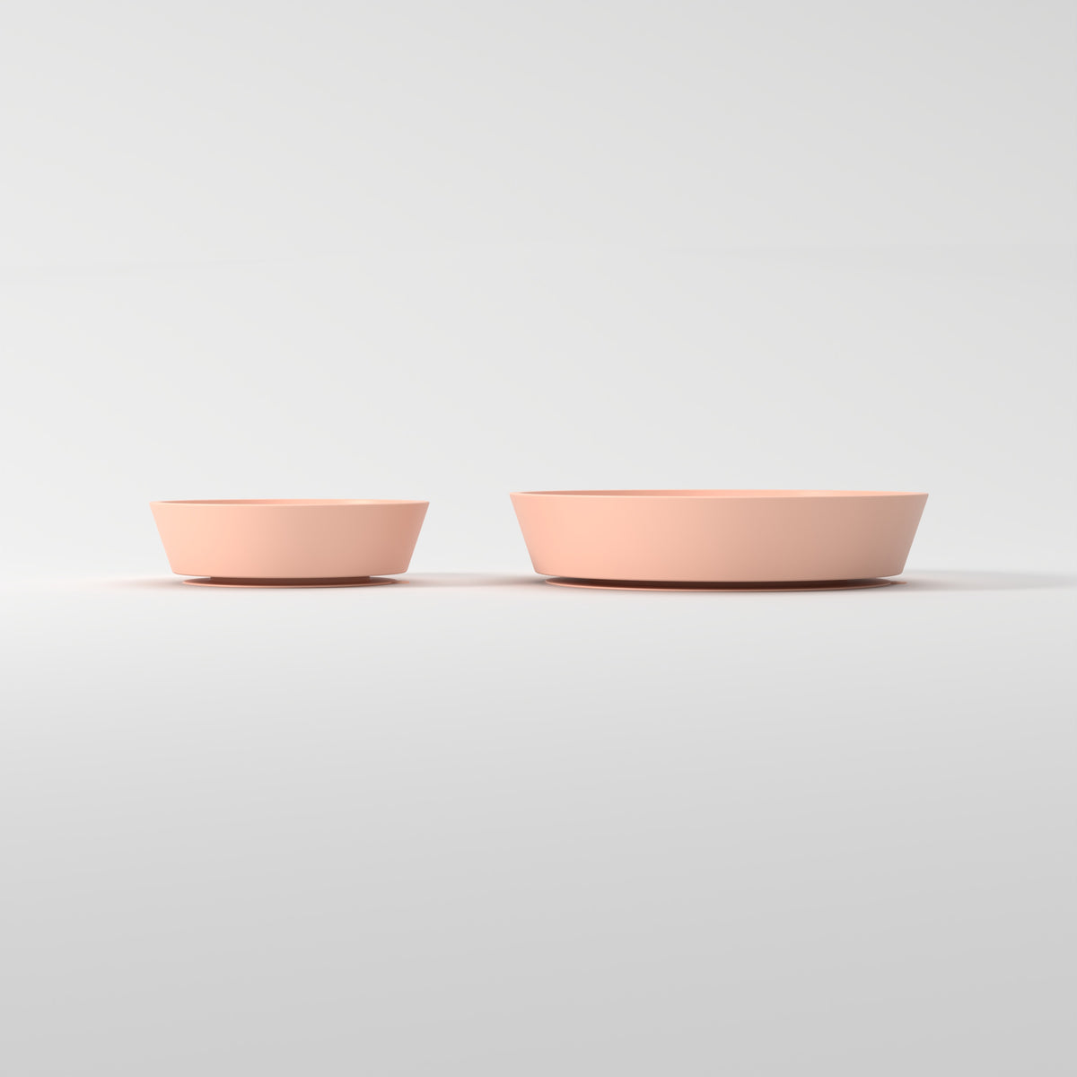 Small and Medium Peach Flower + Leaf slow feeder bowls, size comparison side studio view
