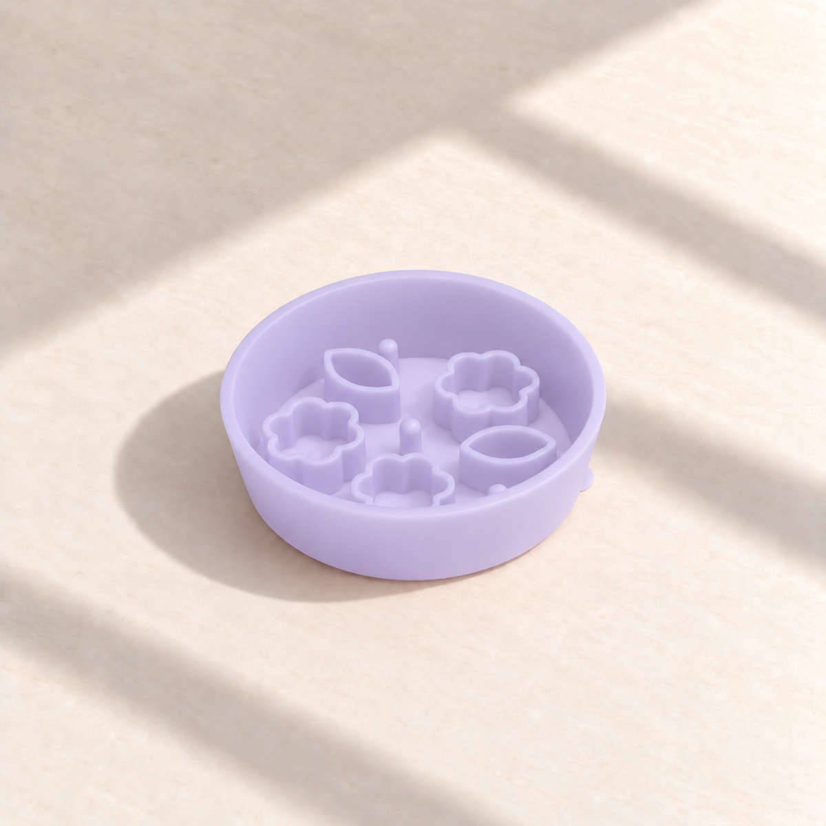Jelly Purple Flower + Leaf slow feeder bowl, 5.5-inch diameter, empty on a sunlit cream table
