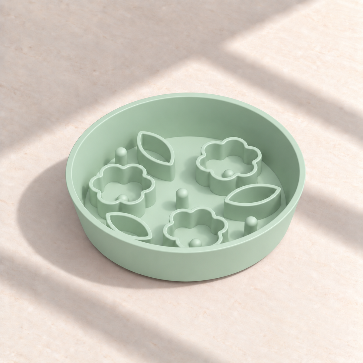 Green Flower + Leaf slow feeder bowl, 8-inch diameter, empty on a sunlit cream table