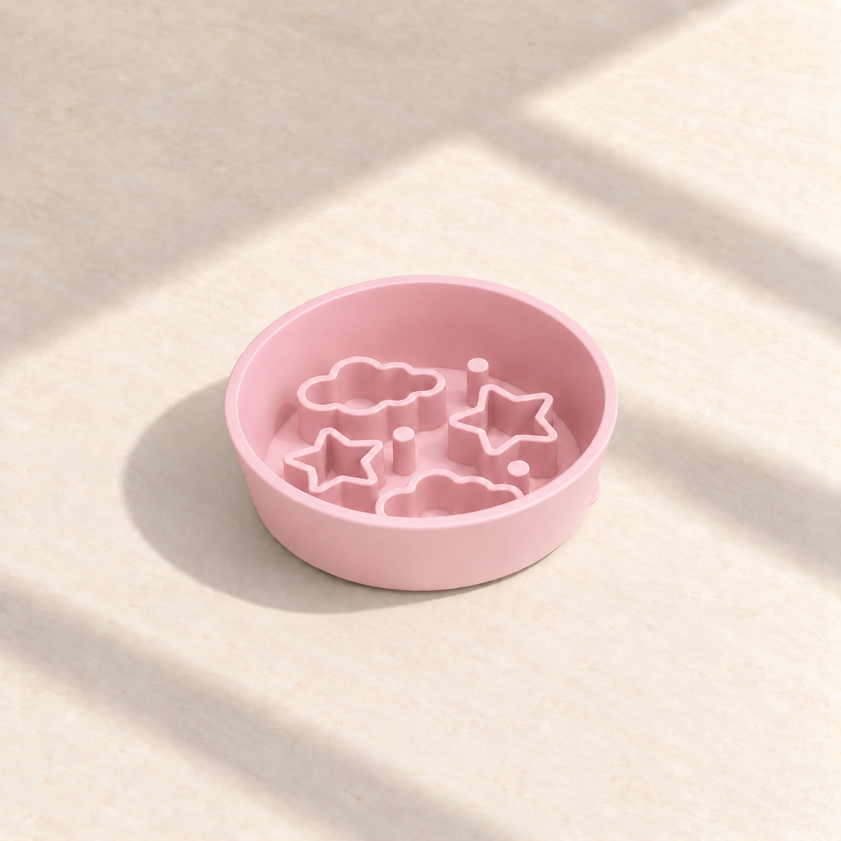 Pink Star + Cloud slow feeder bowl, 5.5-inch diameter, empty on a sunlit cream table