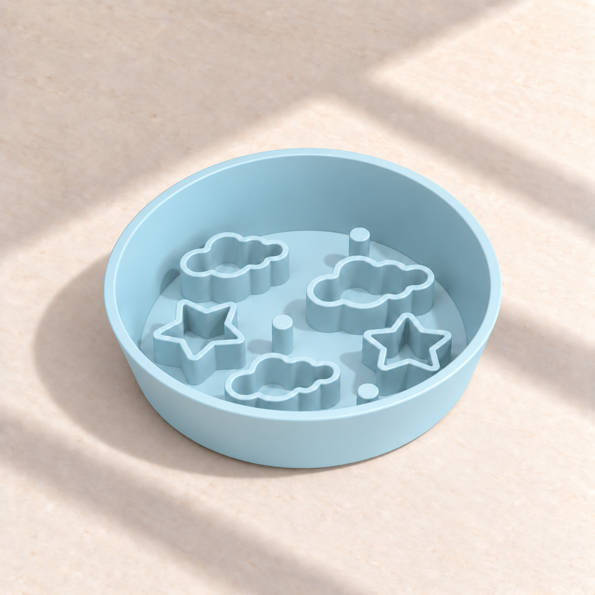 Blue Star + Cloud slow feeder bowl, 8-inch diameter, empty on a sunlit cream table