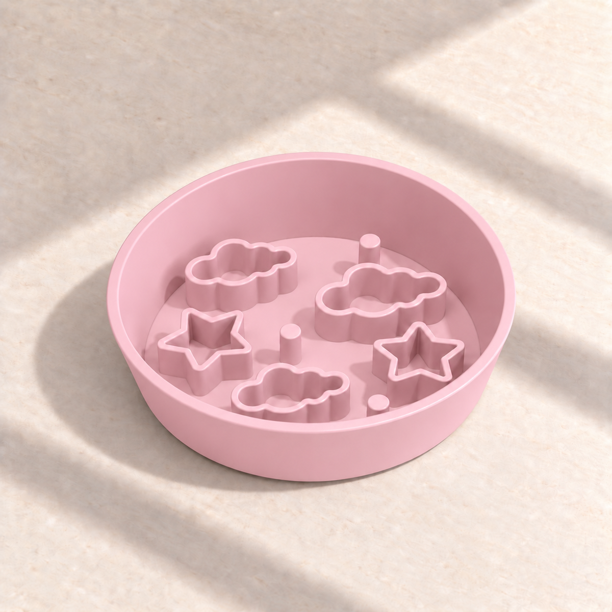 Pink Star + Cloud slow feeder bowl, 8-inch diameter, empty on a sunlit cream table